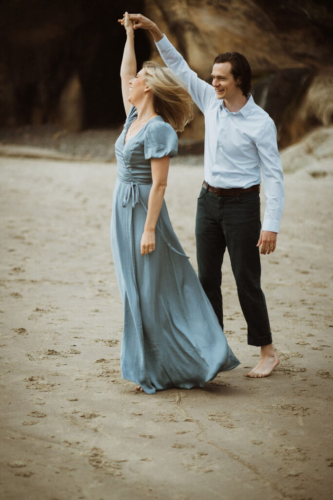 Couple dancing on the beach at Hug Point during engagement session