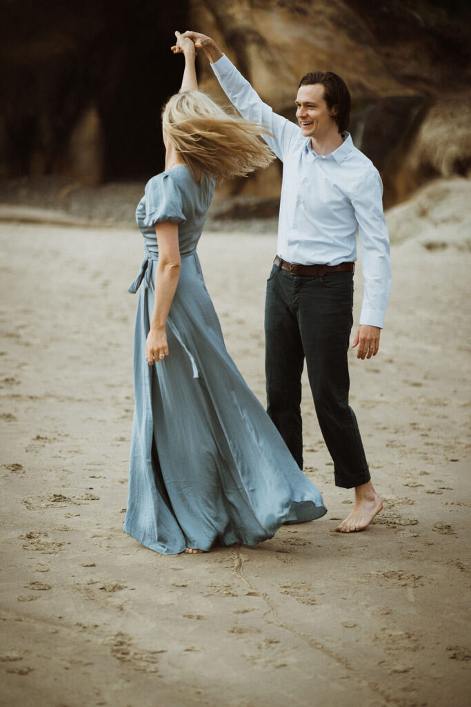 Couple dancing on the beach at Hug Point during engagement session