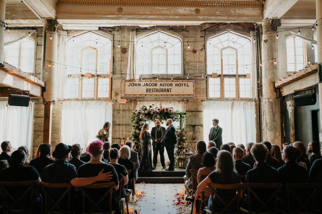 Dark wedding ceremony at The Ruins at the Astor