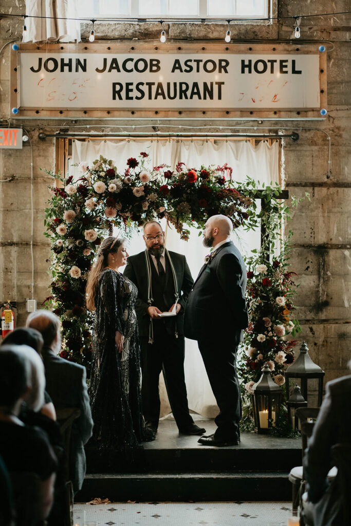 Dark wedding ceremony at The Ruins at the Astor