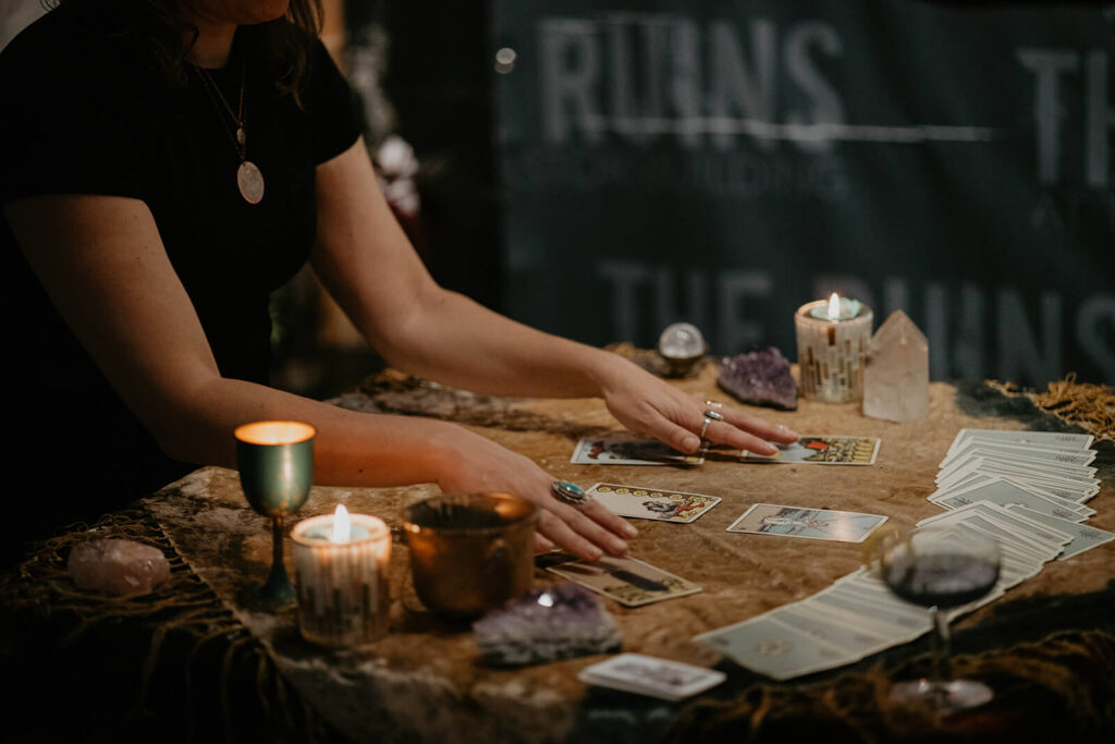 Tarot card reading at dark, moody fall wedding