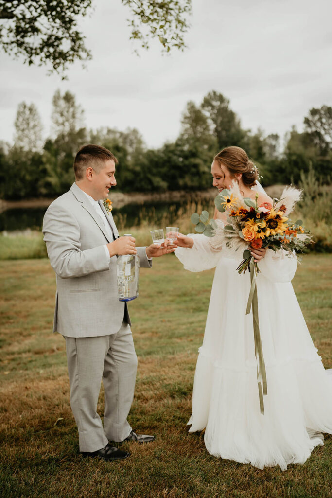 Bride and groom take shots after first look at Pemberton Farm