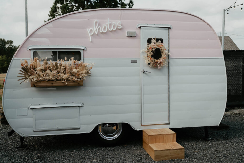 Pink and white photo trailer at wedding in Washington