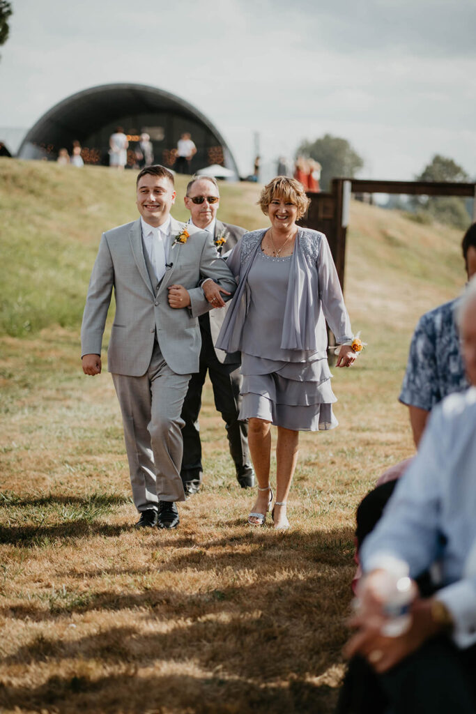 Groom walks mother down the aisle at wedding in Washington