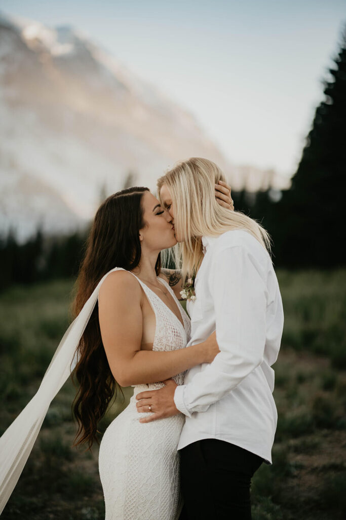 Two brides kissing during outdoor elopement at Mt Rainier