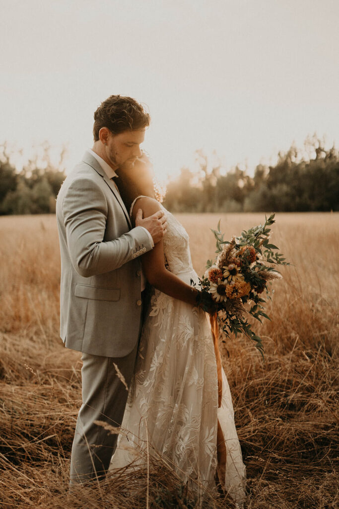 Bride and groom outdoor wedding portraits in the meadow at CedarVale Events wedding