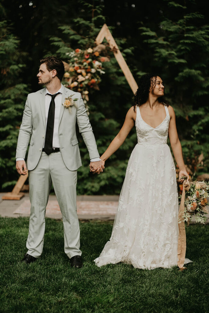 Bride and groom portraits in front of A frame wedding arch at CedarVale Events wedding venue