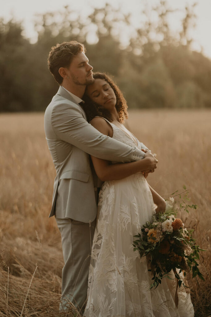 Bride and groom outdoor wedding portraits in the meadow at CedarVale Events wedding