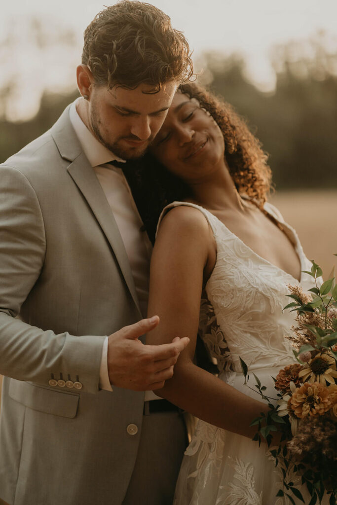 Bride and groom outdoor wedding portraits in the meadow at CedarVale Events wedding