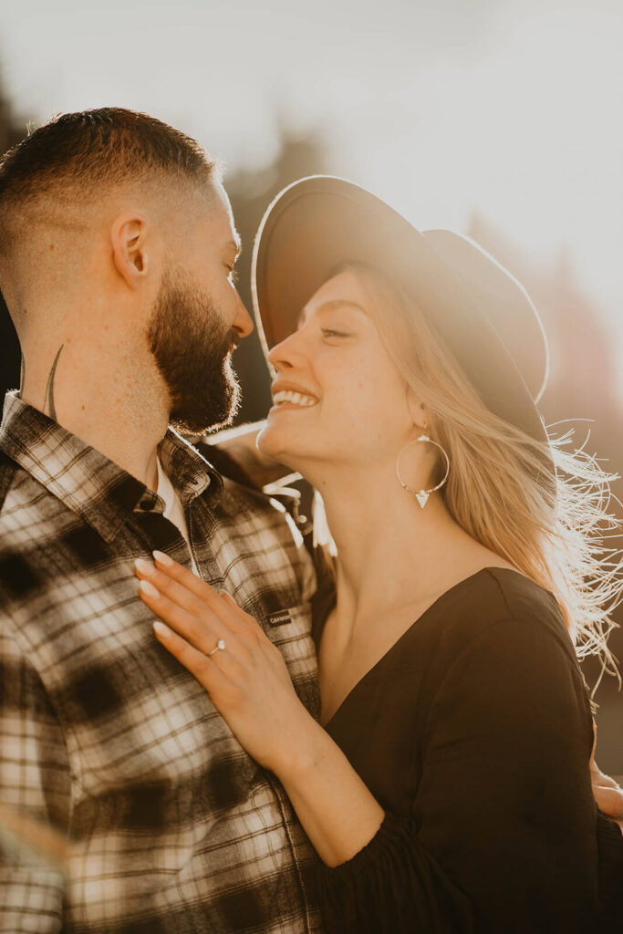 Couple smiling during winter engagement photos in Oregon