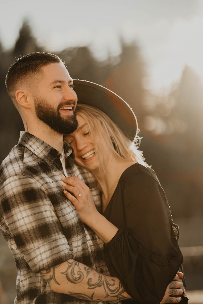 Couple laughing during winter engagement photos in Oregon