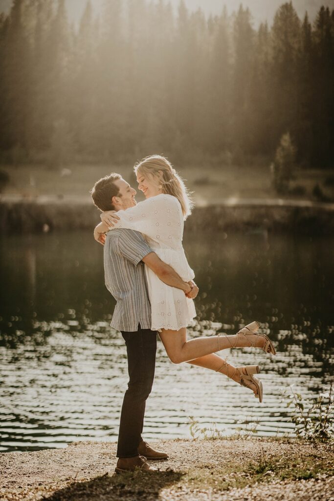 Couple hugging during mountain engagement photos in Banff, Canada