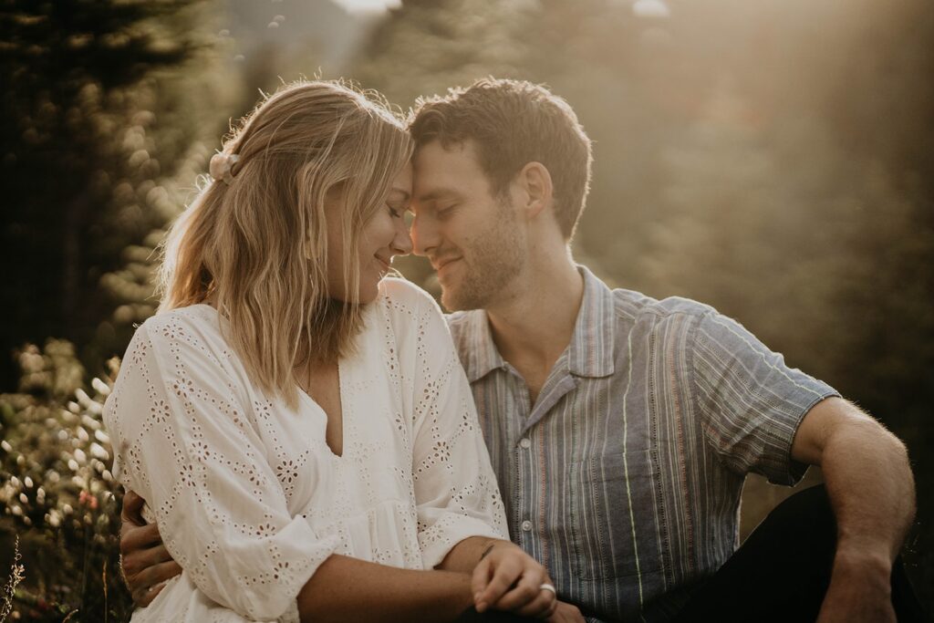 Couple touching foreheads during their mountain engagement photos in Canada