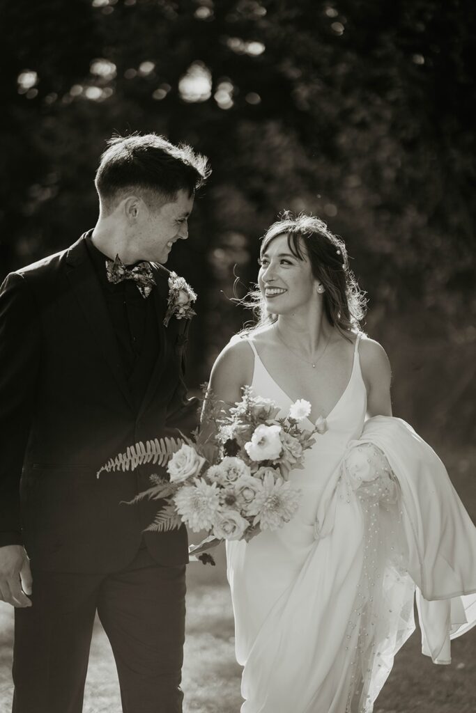 Bride and groom walking to the wedding ceremony after their wedding portraits by the Columbia River