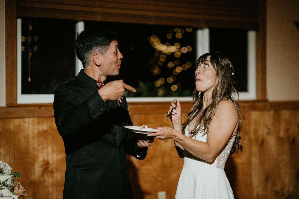 Bride and groom cut three tier wedding cake at Cascade Locks wedding reception