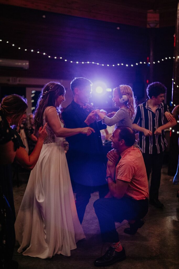 Bride and groom dancing with guests on the dance floor at their Cascade Locks wedding in Oregon