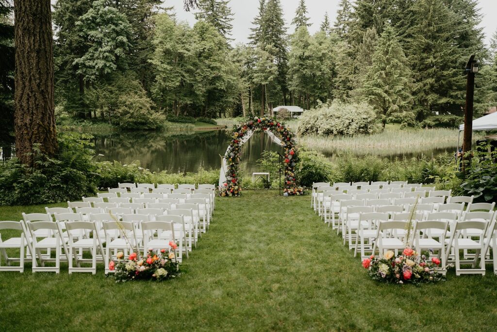 Colorful flowers decorating the wedding ceremony arch at outdoor wedding at Bridal Veil Lakes 