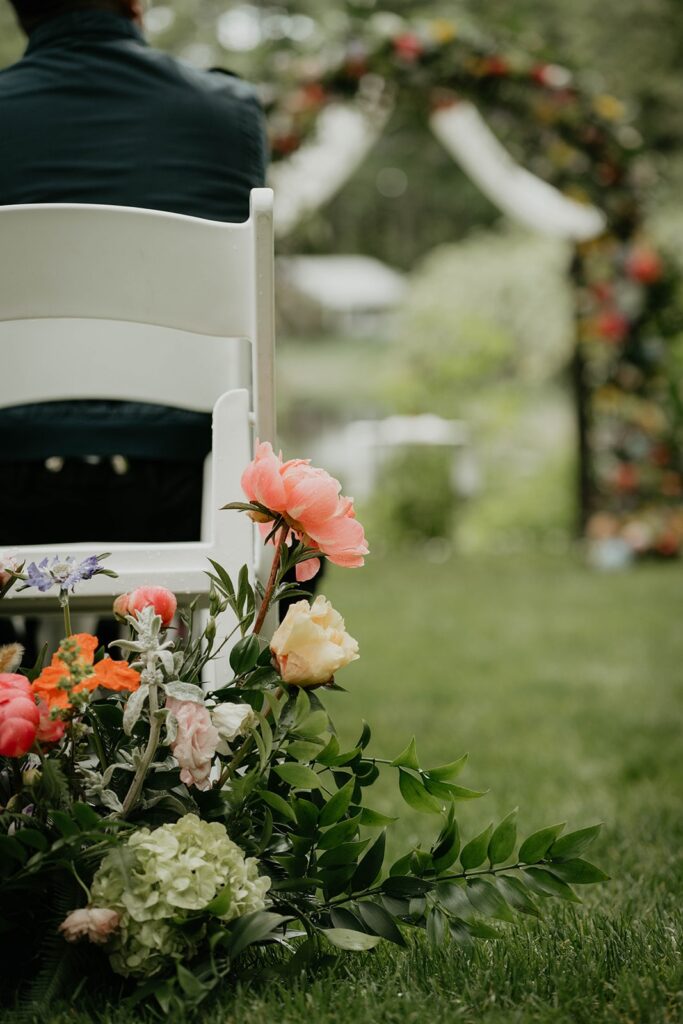 Colorful flowers decorating the aisle at outdoor modern Asian wedding