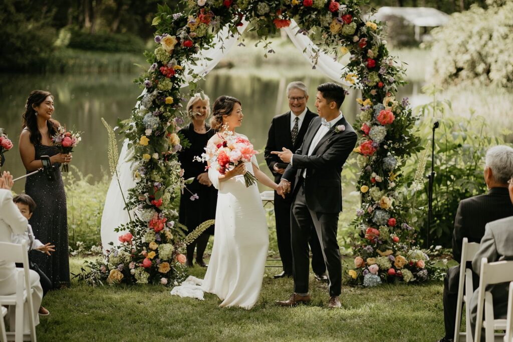 Bride and groom exit their outdoor wedding ceremony at Bridal Veil Lakes wedding venue