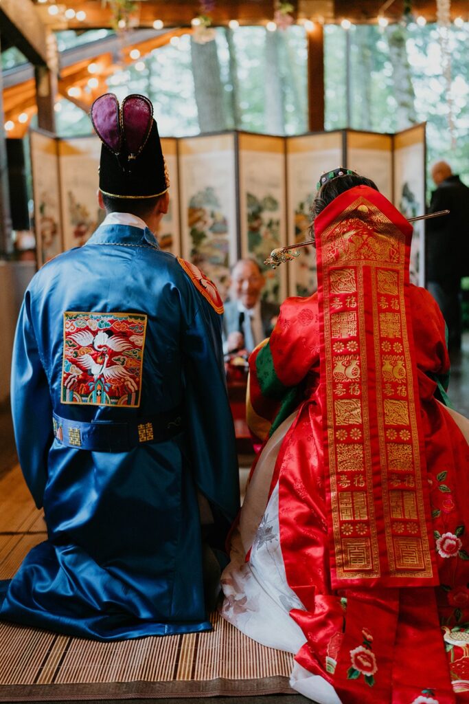 Bride and groom catch chestnuts during traditional Korean wedding ceremony