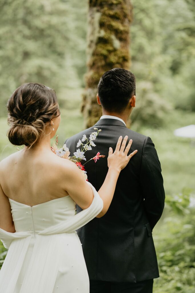 Bride and groom first look on the garden trail at Bridal Veil Lakes