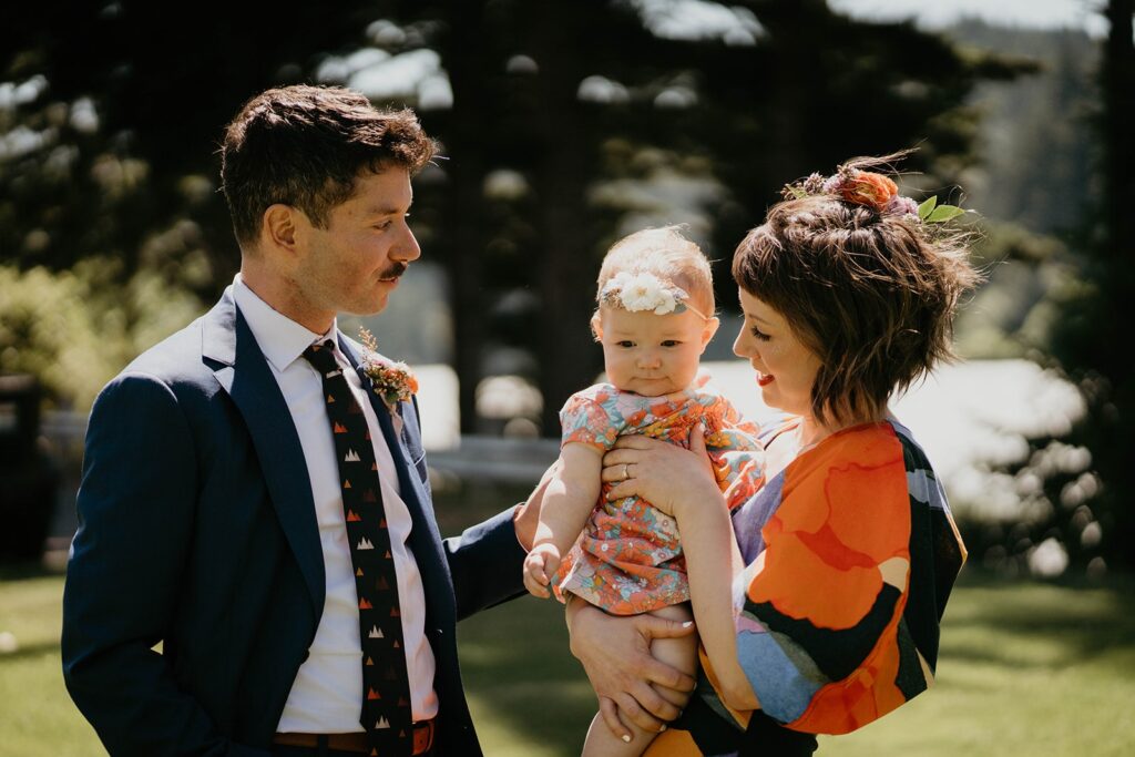 Bride and groom wedding first look with their daughter at Columbia River Gorge