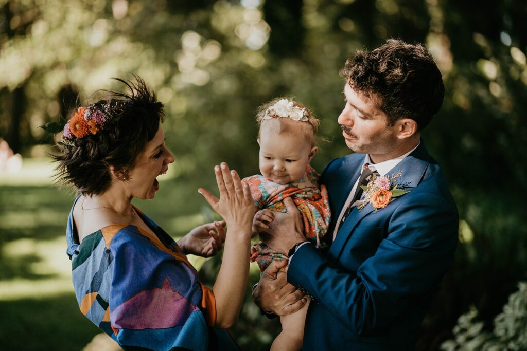 Bride and groom wedding portraits with their baby