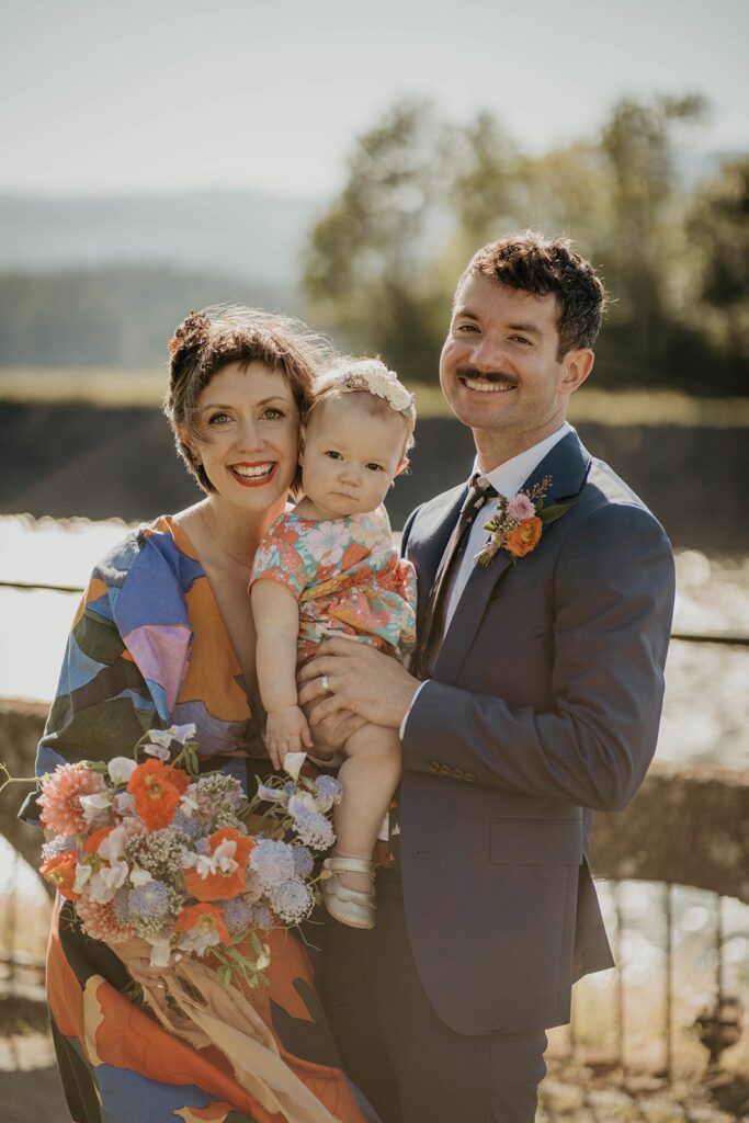 Bride and groom wedding portraits with their baby in Cascade Locks