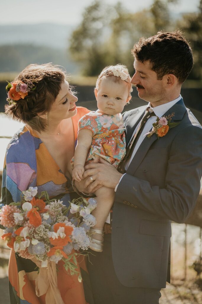 Bride and groom wedding portraits with their baby in Cascade Locks