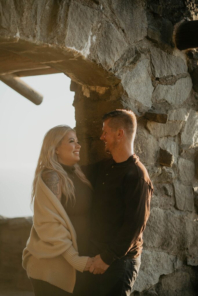 Couple standing at Cape Perpetua viewpoint for their Oregon Coast engagement photos