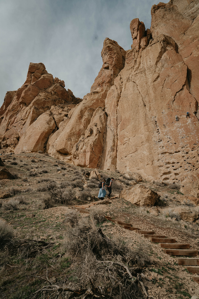 A couple climbing up stairs on their way to climb at Smith Rock.m