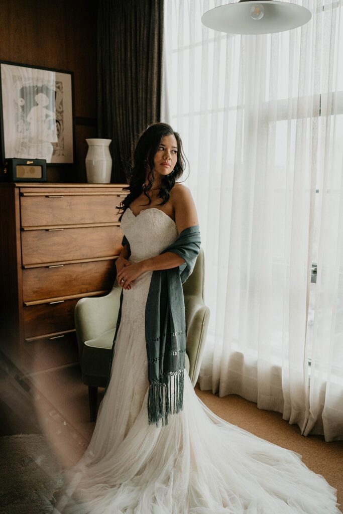 Bride wearing white wedding dress and blue shawl 