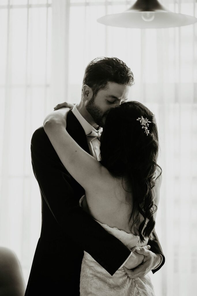 Bride and groom hug after first look at Blockhouse PDX