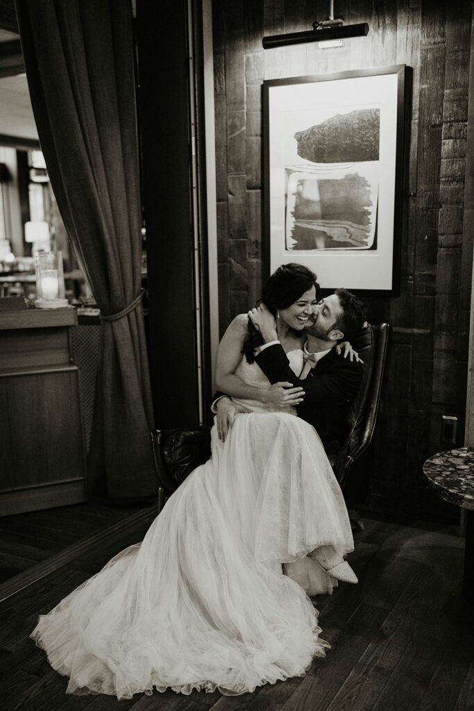 Bride and groom kiss and laugh during wedding photos at Blockhouse PDX