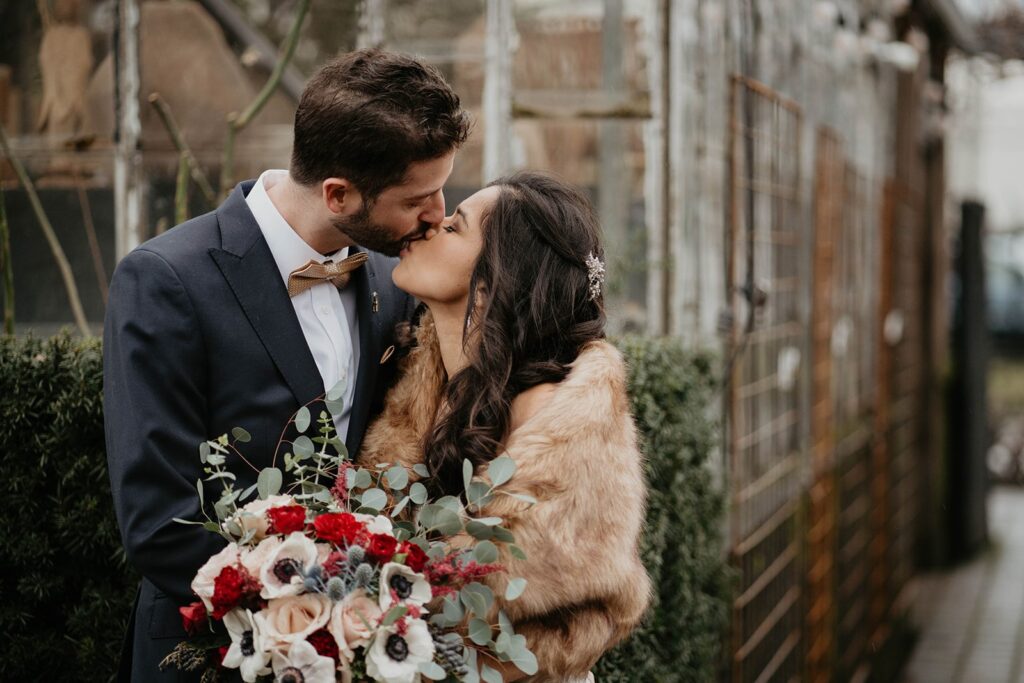 Bride and groom kiss during wedding portraits at their Blockhouse Portland wedding