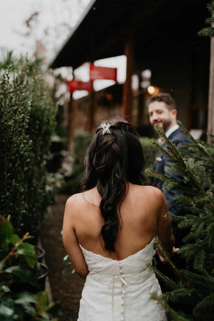 Bride and groom walk through the plants at Pomarius Nursery for their Blockhouse Portland wedding photos