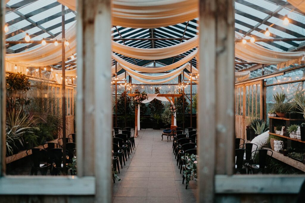 Blockhouse Portland wedding venue with black chairs and wood ceremony arch