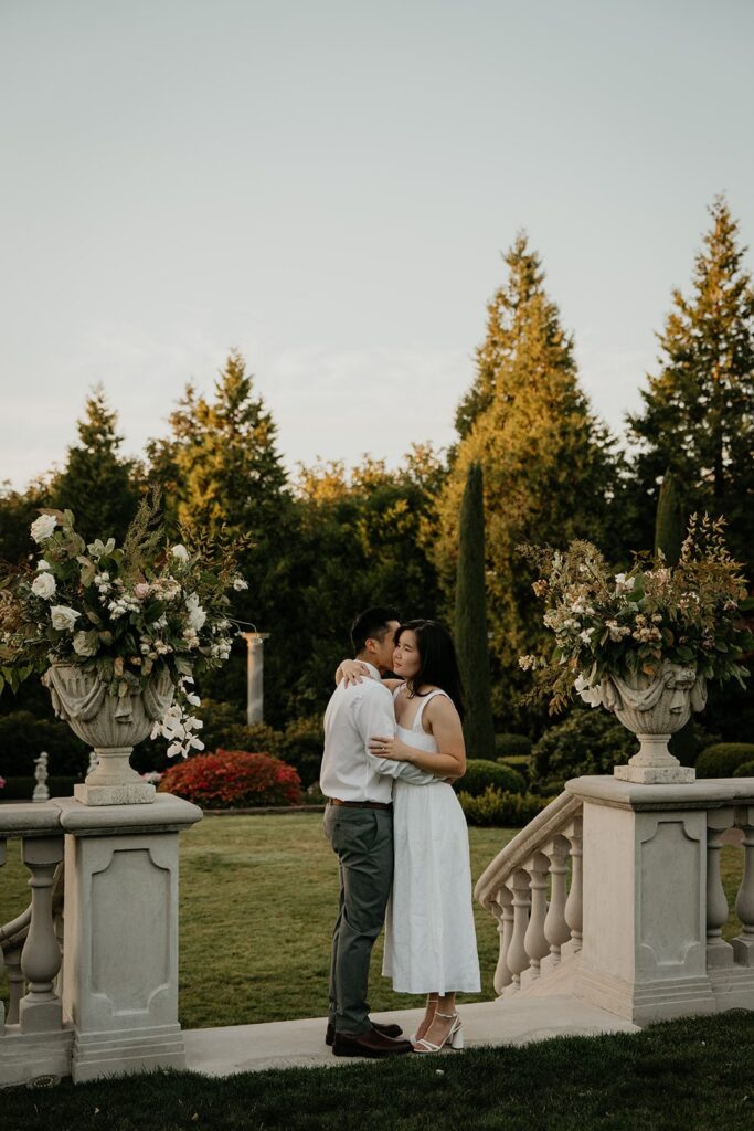 Couple dances on an outdoor patio during their Oregon engagement photo session at Chateau de Michellia