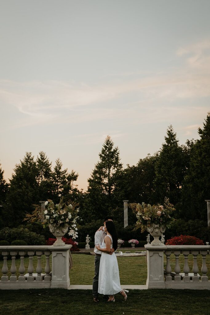 Couple dances on an outdoor patio during their Oregon engagement photo session at Chateau de Michellia