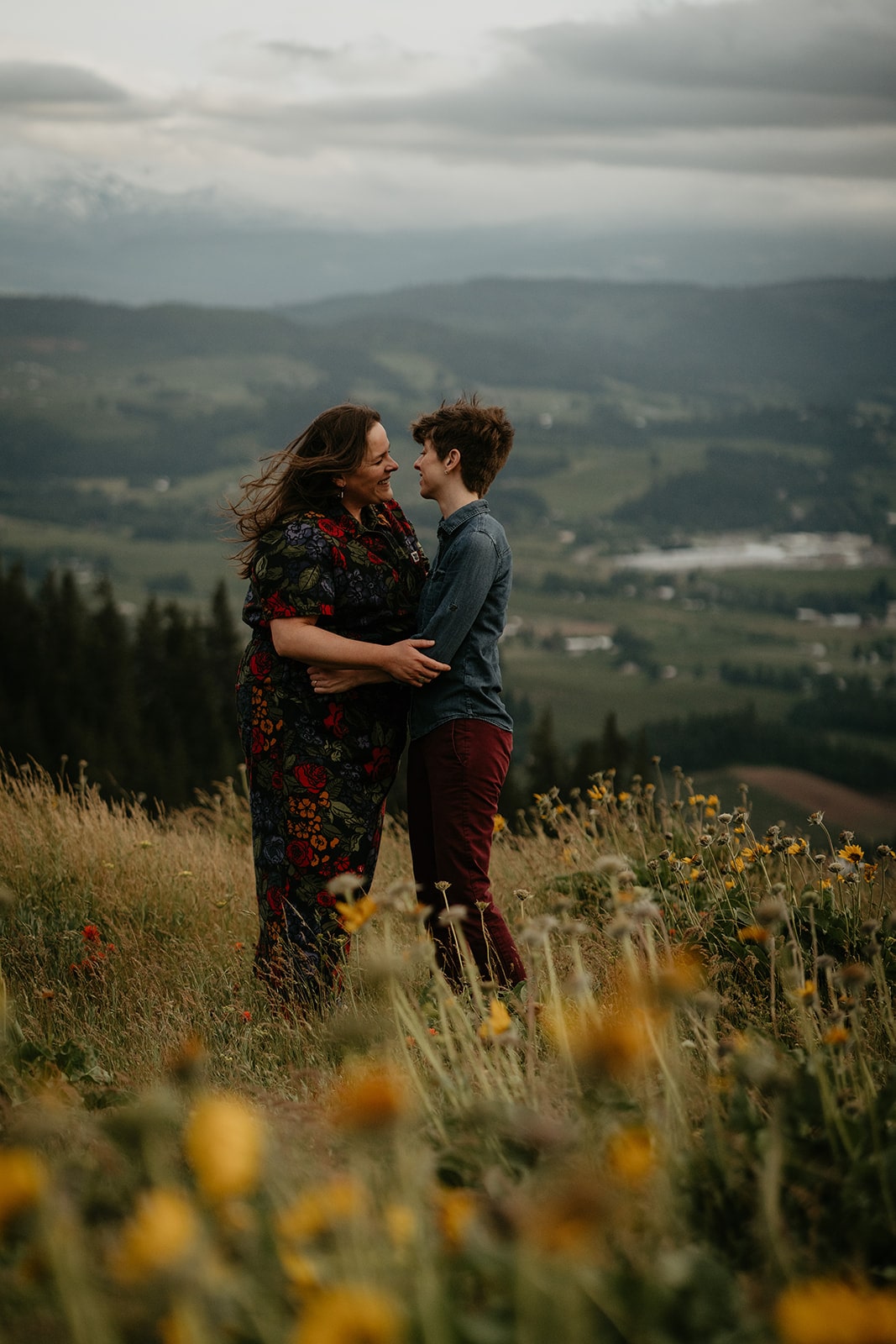 Same sex couple goes in for a kiss during their Hood River Mountain engagement session in Oregon