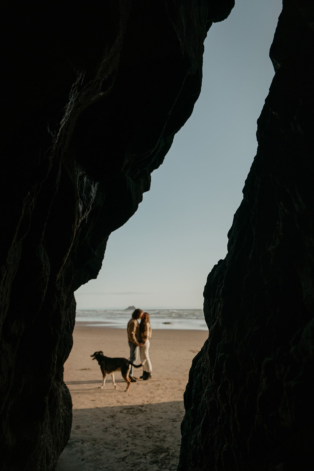 Couple kisses on the beach during their Hug Point Oregon engagement photo session