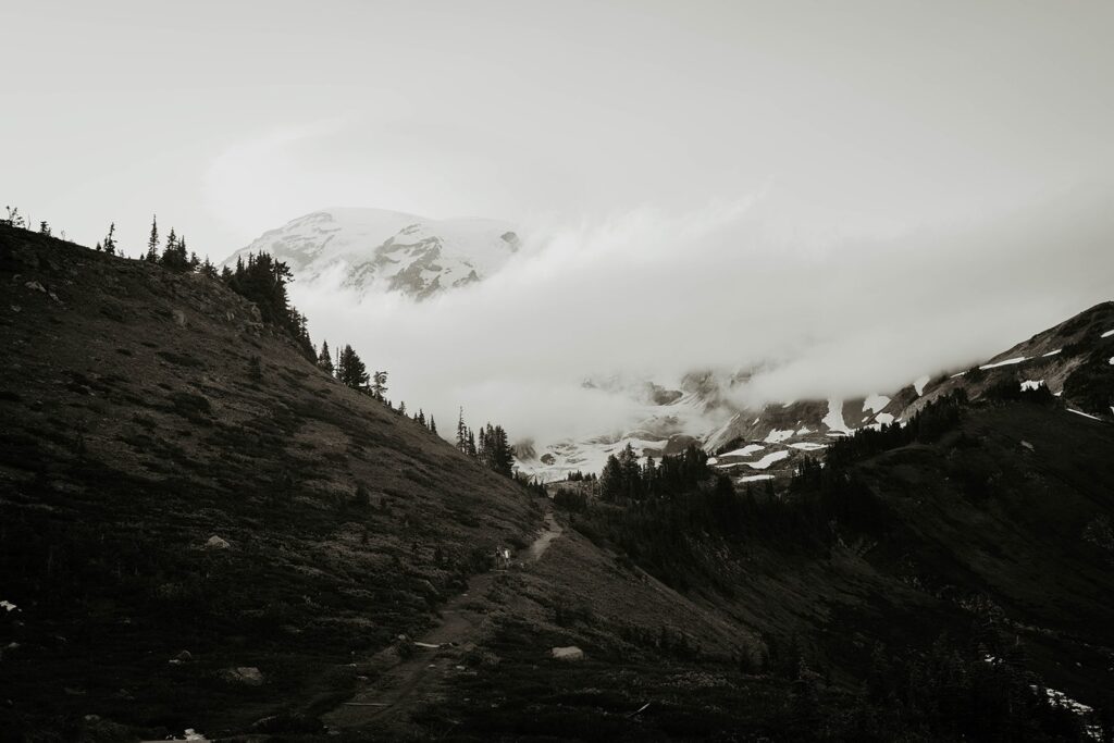 Couple walking up a trail at Mt Rainier for their hiking engagement photos