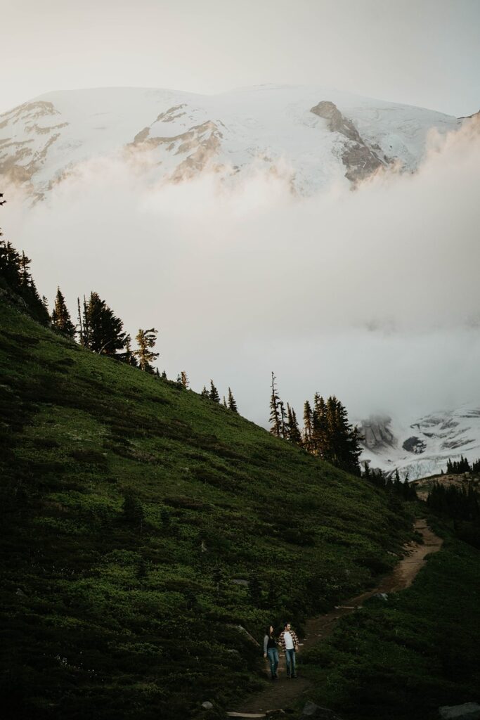 Couple walking down a trail at Mt Rainier for their hiking engagement photos