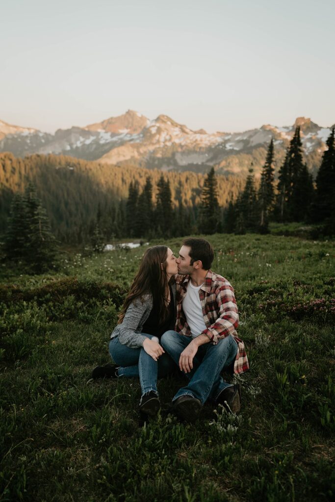 Couple kissing in the grass during Mt Rainier engagement photos at Paradise