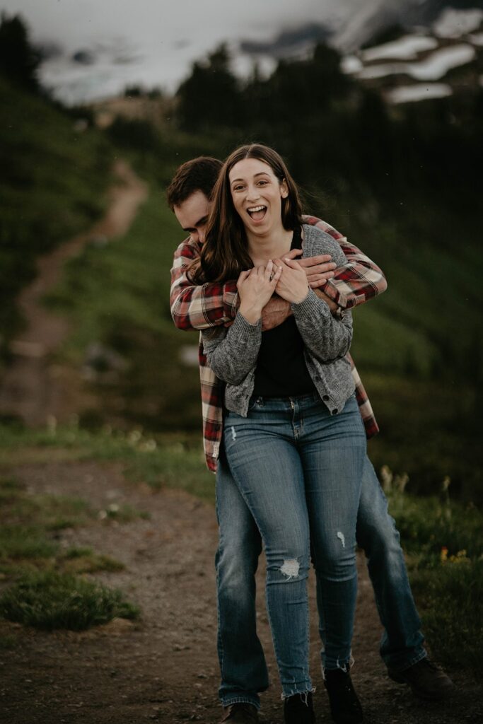 Couple laughing during sunset hiking engagement photos at Paradise, Mt Rainier