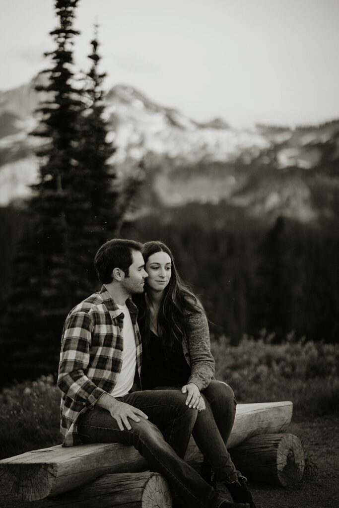 Couple sitting on a bench at sunset during Mt Rainier engagement photos