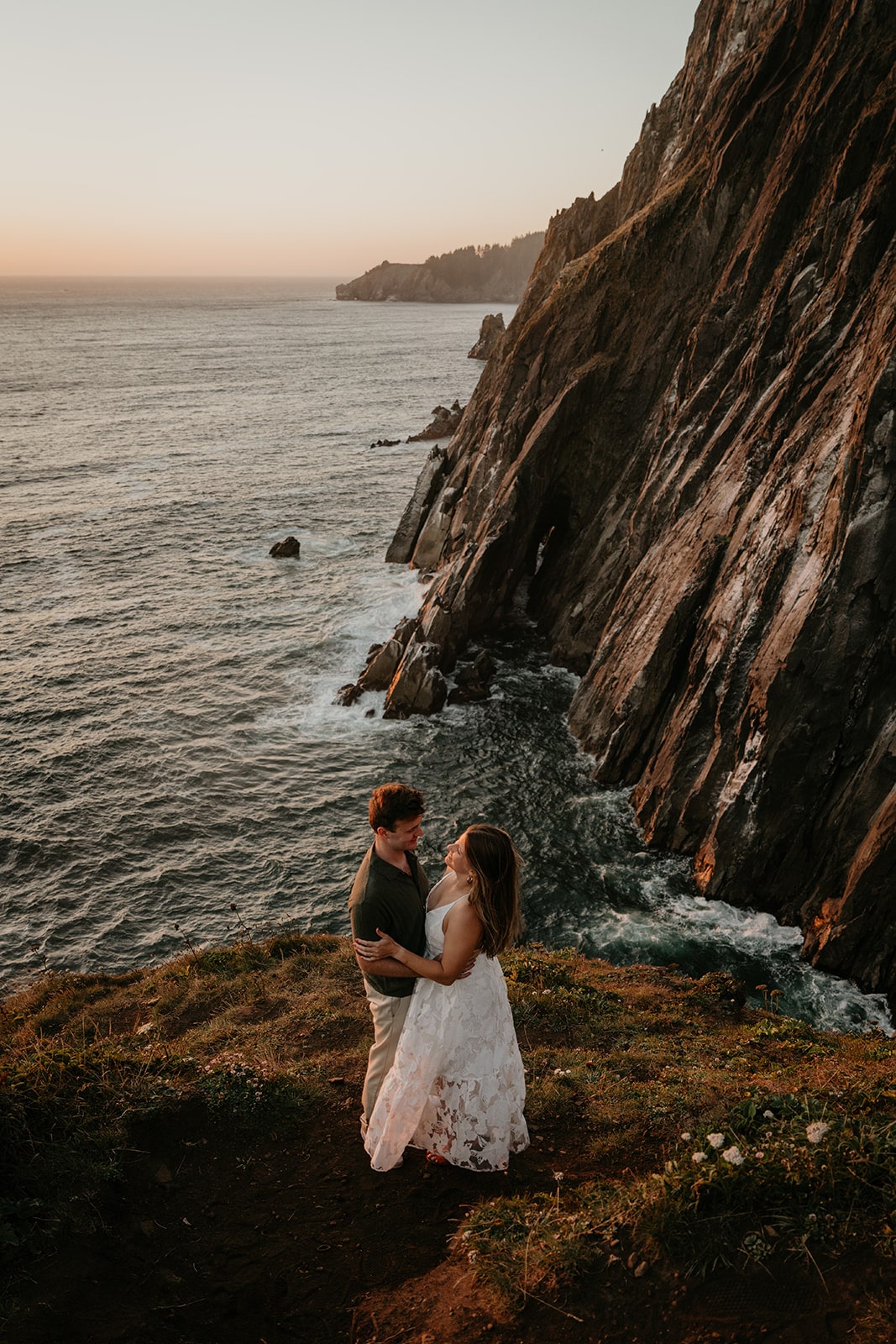 Couple hugs at an Oregon engagement photo location on the Oregon Coast