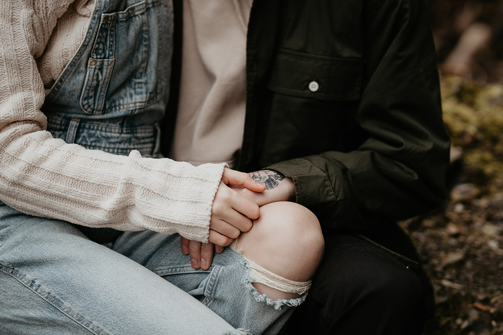 A close up of a couple holding hands at the Columbia River Gorge. 