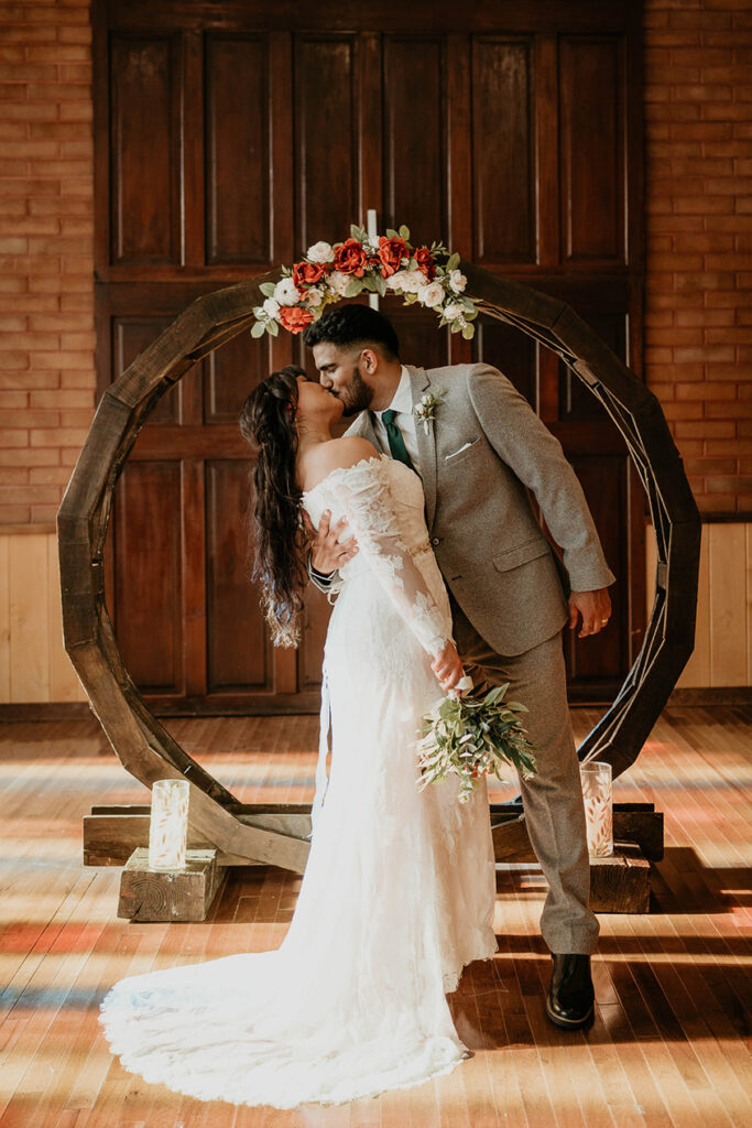 The bride and groom kissing in Hubbard Chapel. 