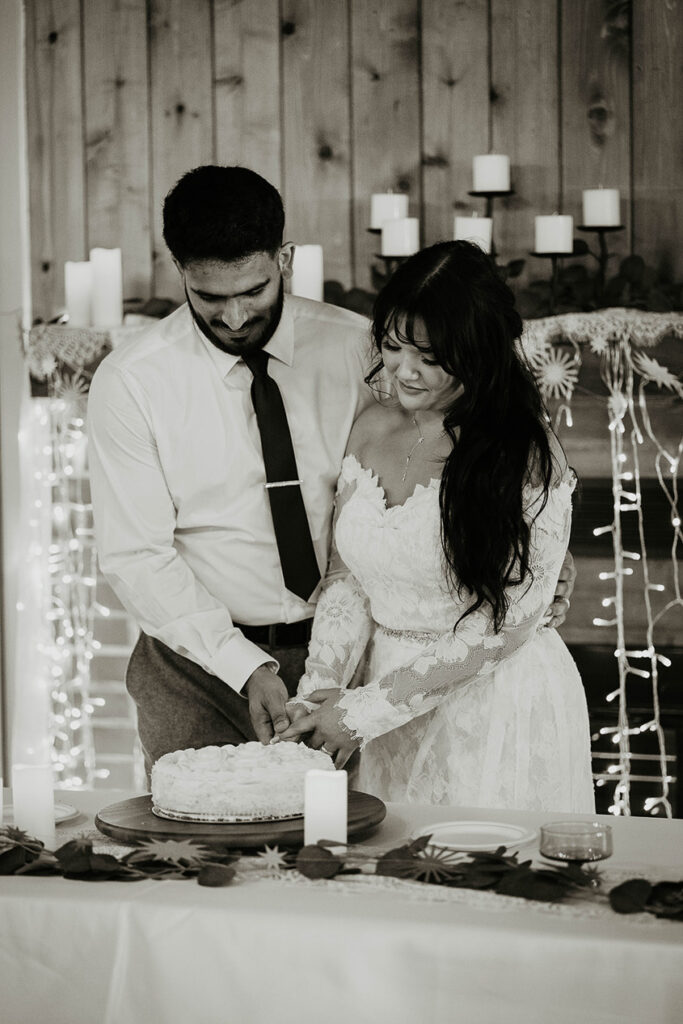 The bride and groom making the first slice into the wedding cake. 